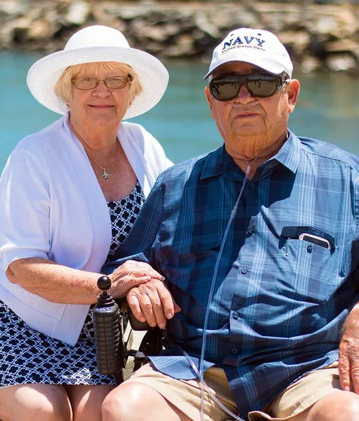 Senior couple sitting outdoors together on a sunny day